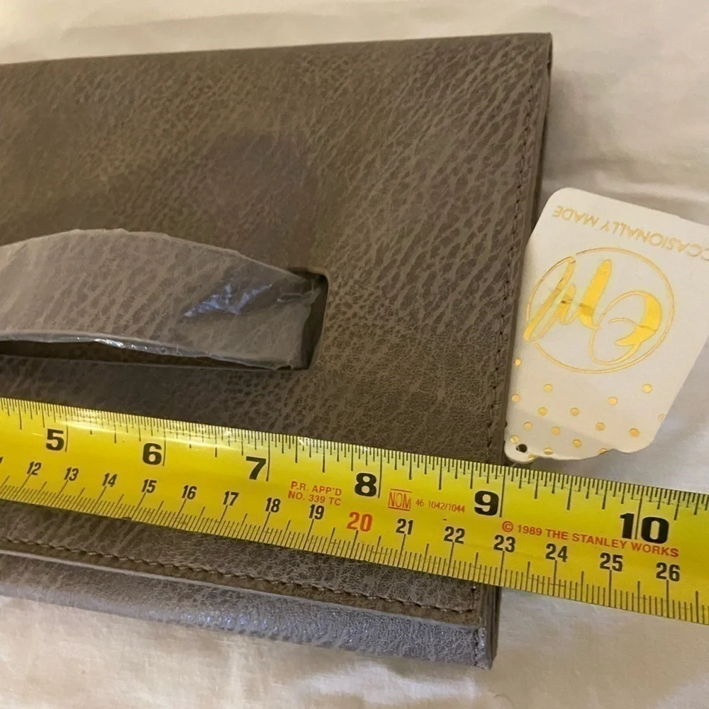 Occasionally made clutch Metallic Leather hand clutch. 9” wide 6” tall new